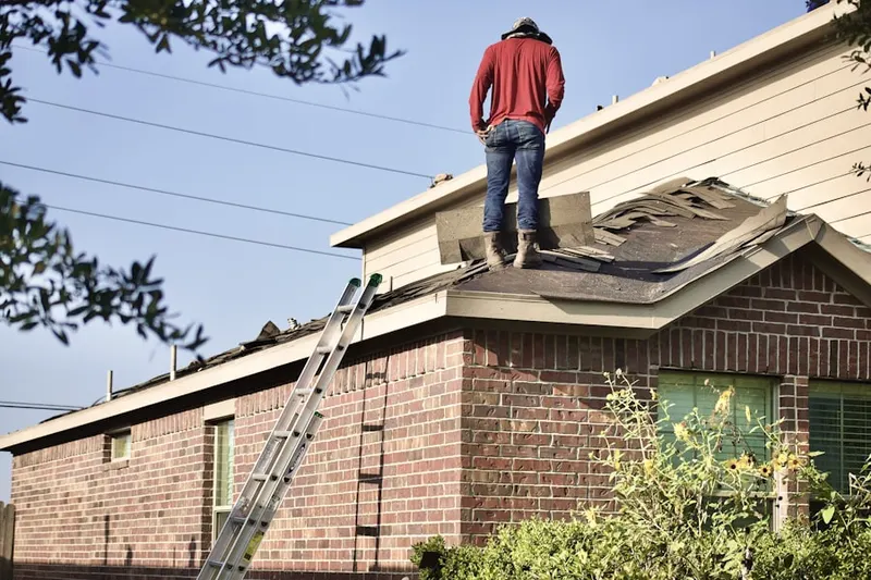 Professional roofer working on a residential roof in Destin